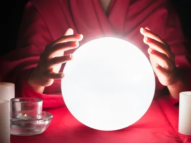 A glowing ball is seen with a persons hands around the globe.